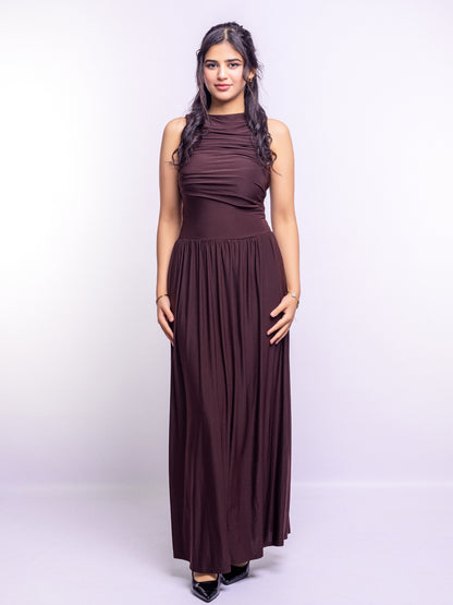 Woman wearing a long brown dress on a white background