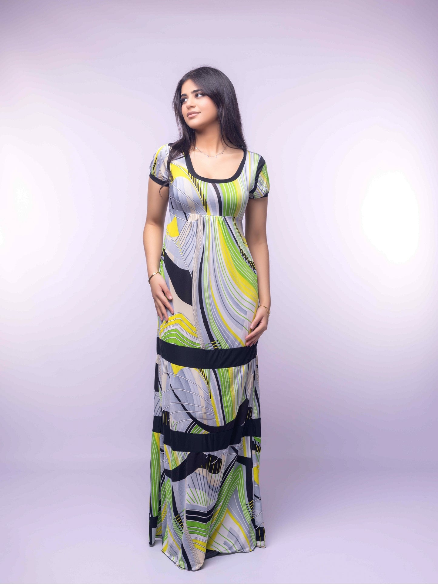 Woman wearing a patterned dress on a white background
