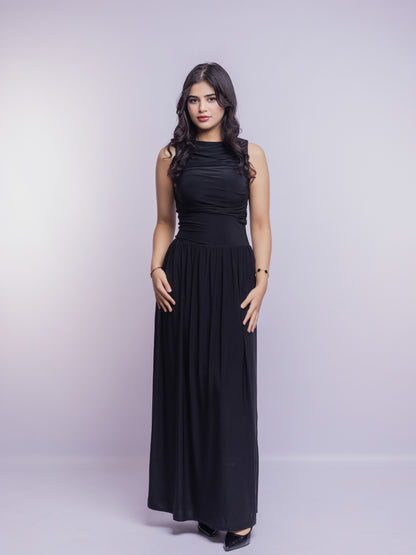 Woman wearing a black sleeveless dress against a light gray background