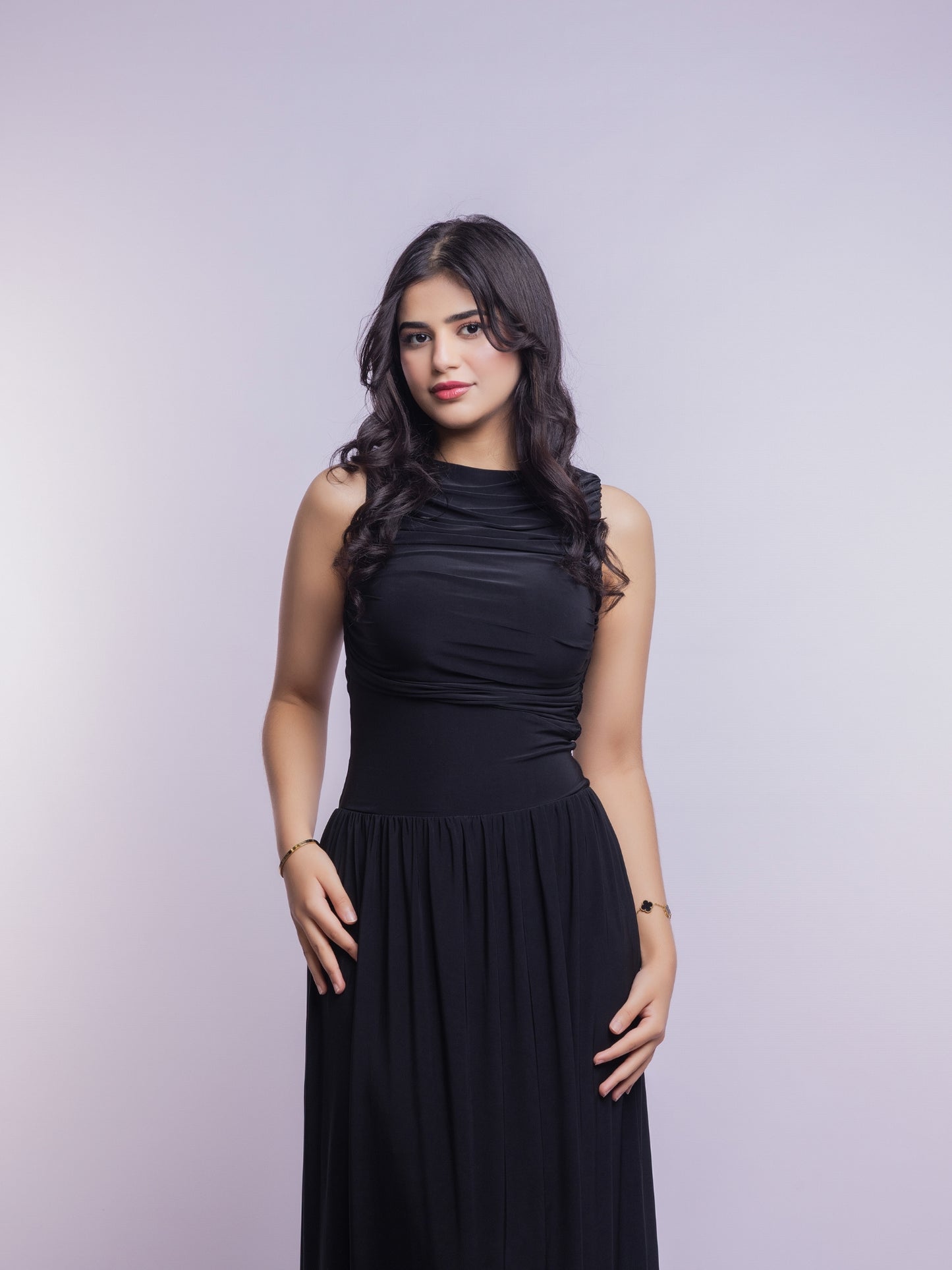 Woman wearing a black dress against a light gray background