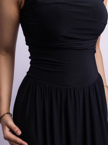 Black dress on a mannequin against a light purple background