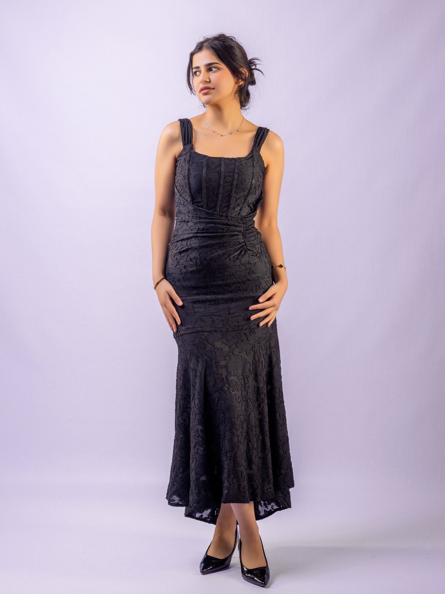 Woman wearing a black dress against a white background