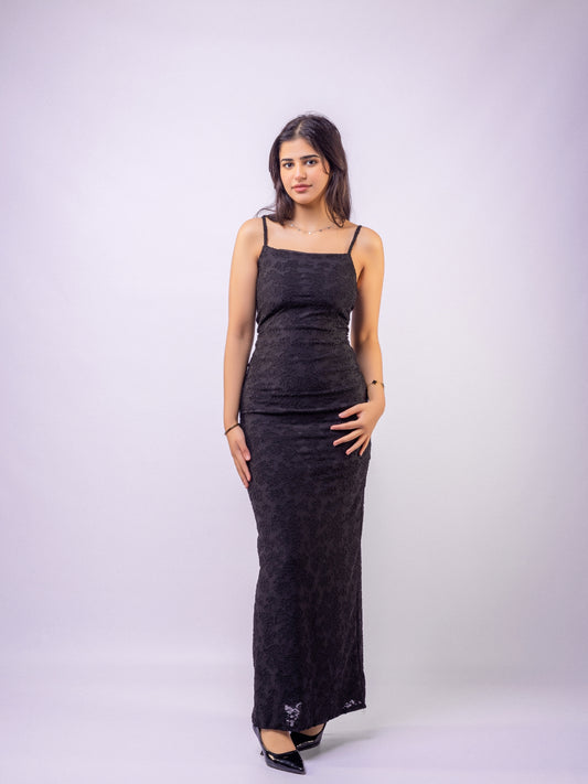 Woman wearing a black dress against a white background