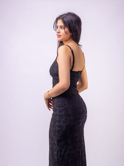 Woman wearing a black dress against a white background