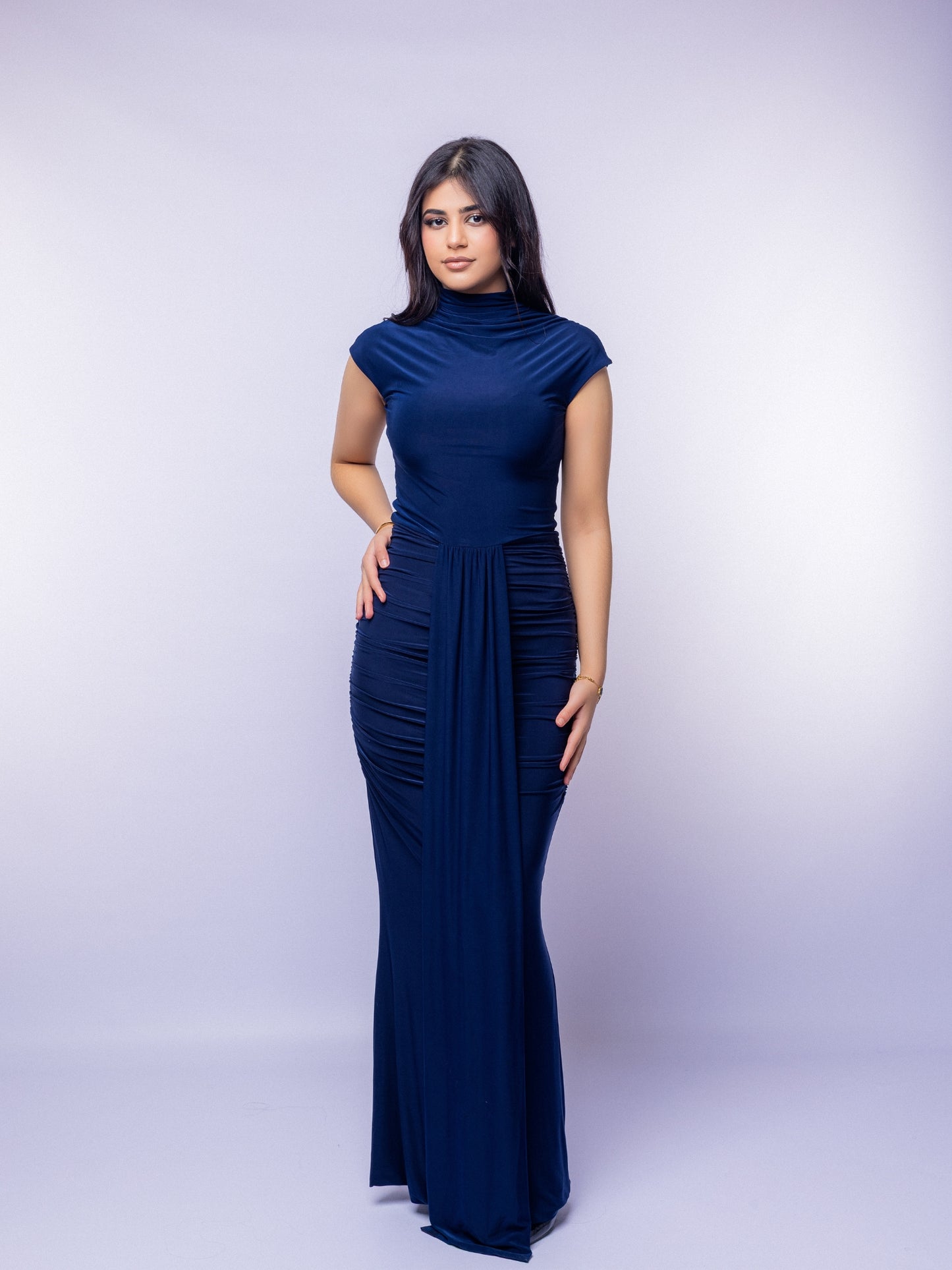 Woman wearing a navy blue dress against a white background