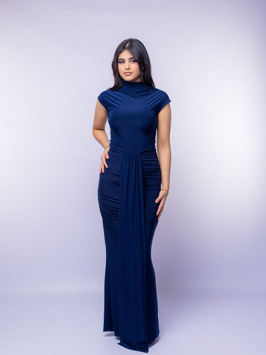 Woman wearing a navy blue dress against a white background