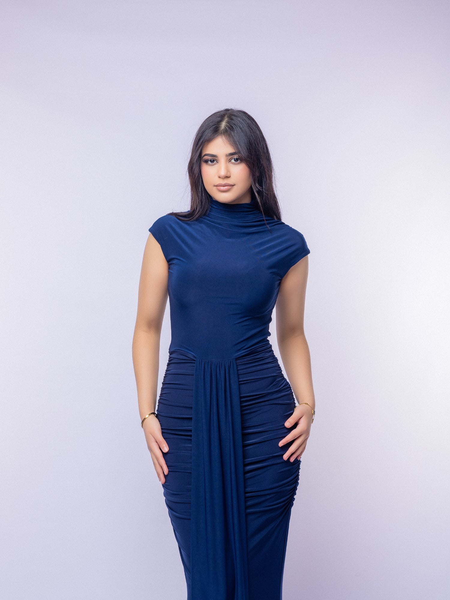 Woman wearing a blue dress against a white background