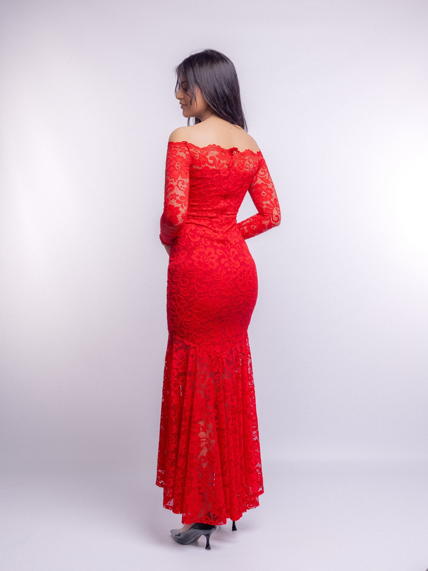 Red lace dress worn by a person on a white background