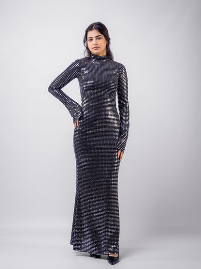 Woman wearing a black sequin dress against a white background
