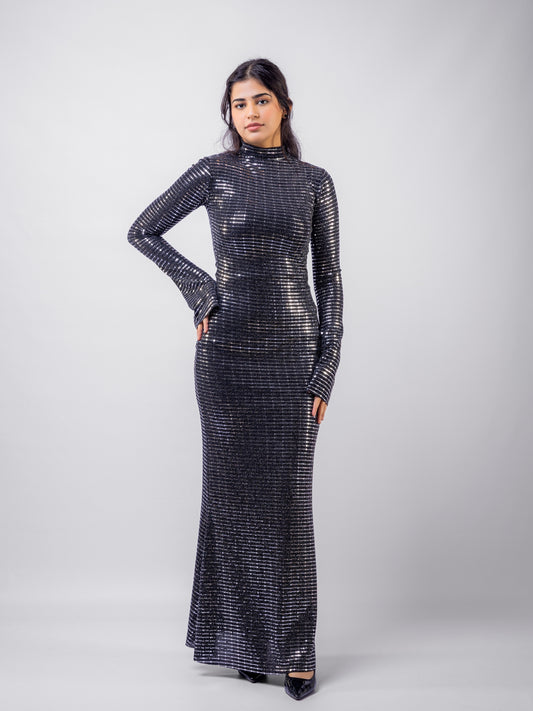 Woman wearing a black sequin dress against a white background