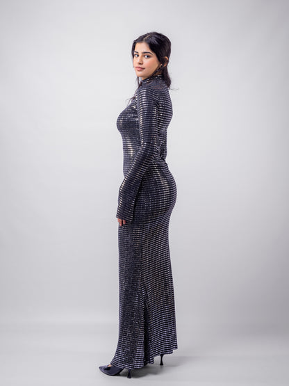 Woman wearing a black and silver patterned dress on a white background