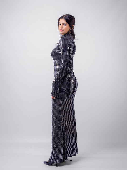 Woman wearing a black and silver patterned dress on a white background