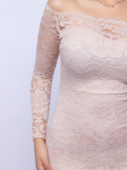 Close-up of a lace dress with long sleeves on a plain background