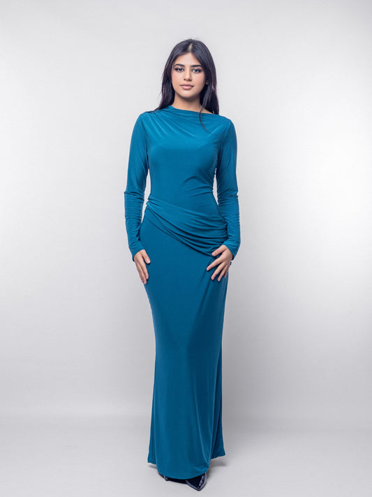 Woman wearing a teal long-sleeve dress against a white background